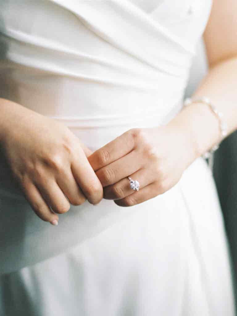 closeup bridal detail of her hands and dress